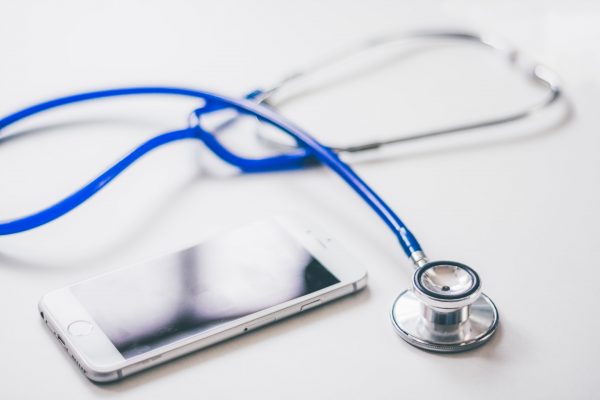 Photo of stethoscope and mobile for online doctor consultation
