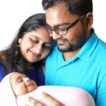 new parents smiling with their new born baby